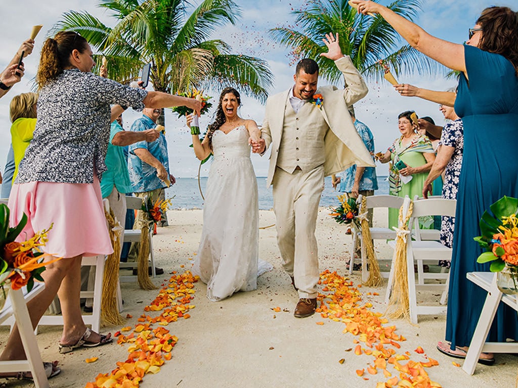 Happy couple just married exiting the wedding ceremony, they choose the Full Micro Wedding Package options.